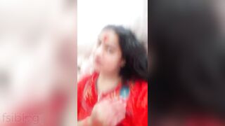 Plump amateur Desi wife in a red sari performs hot XXX striptease
